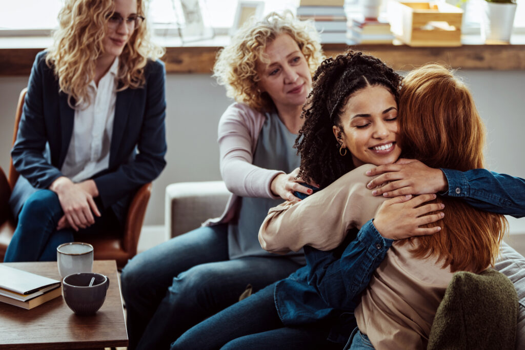 Woman hugging friend after her free abortion information consultation at Alternatives Pregnancy Clinic in Kalamazoo, MI.